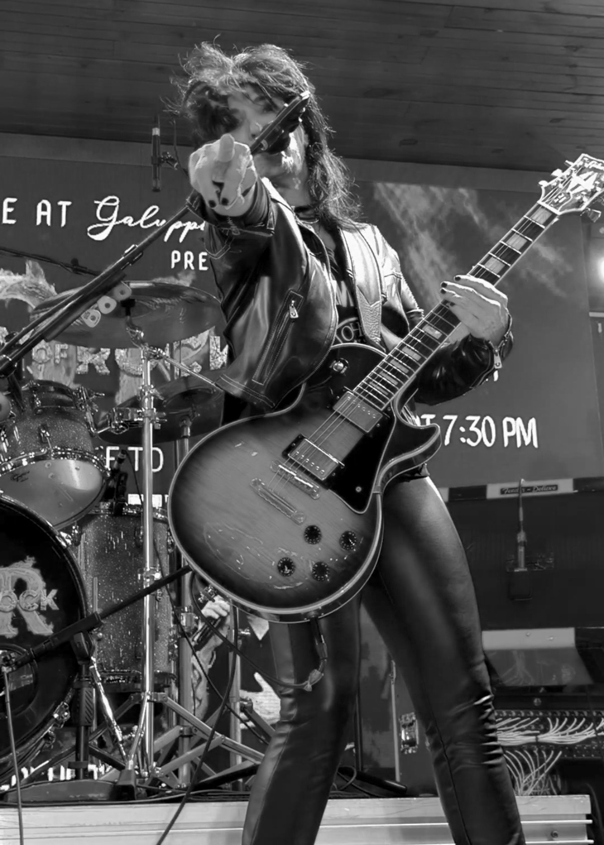 Frontwoman pointing to the crowd, black and white