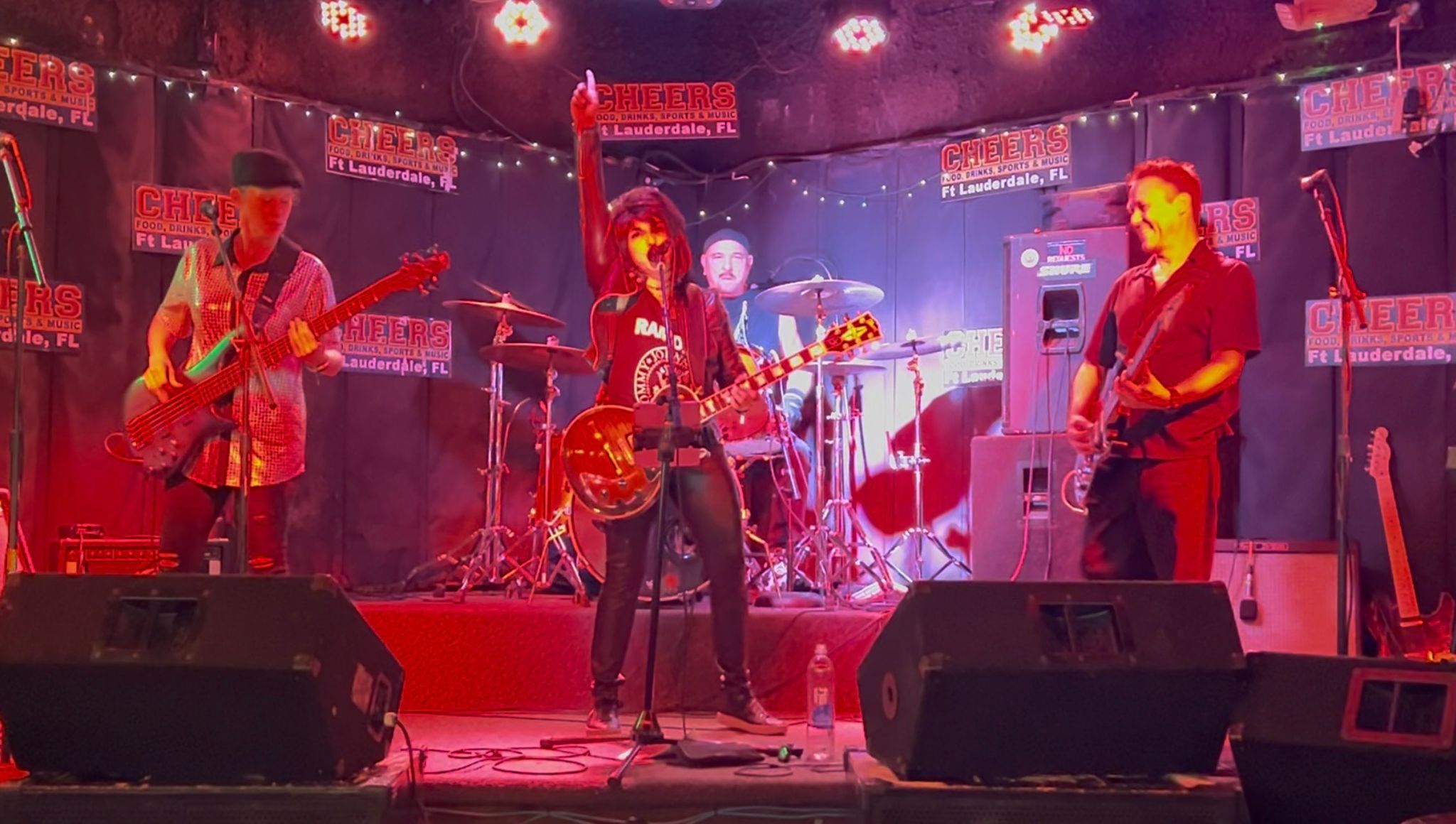 The whole band under red stage lights